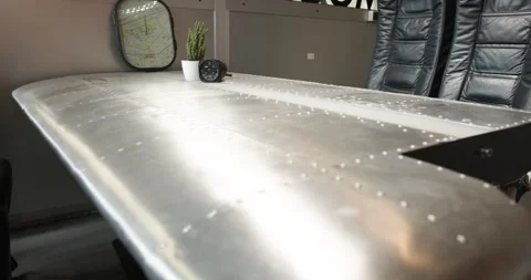 Polished Aircraft Wing Repurposed as Table, Office Interior, Close Up Shot Vídeo Stock 340305098