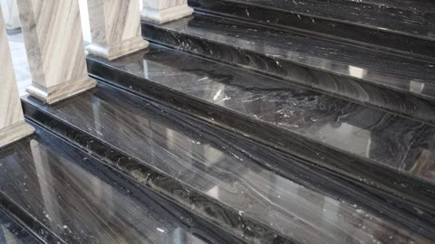 Polished black marble steps with natural vein patterns showcasing luxury and ele Stock Footage 294787664
