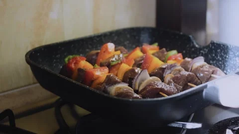 Polished chef-style preparation: placing steak skewers on a ridged grill Stock Footage 342182074