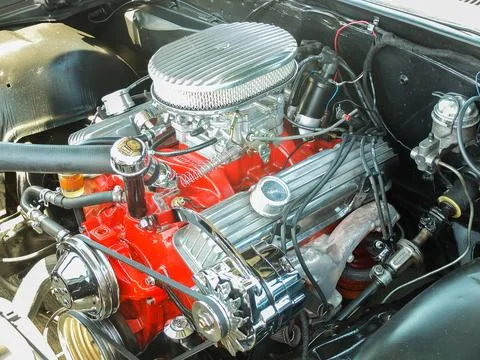 Polished custom V8 engine block with red paint at a classic car show in Rus.. Photos