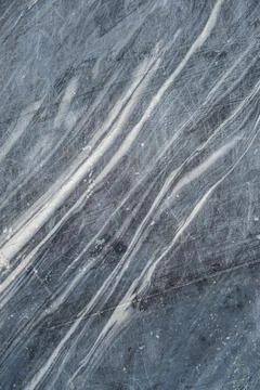 This polished dark marble surface features beautiful white veining patterns.. Stock Photos