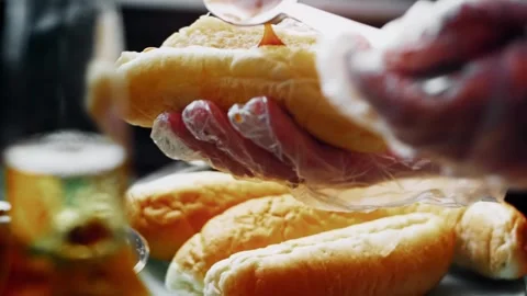 Polished fork holding a cooked sausage above ketchup in wide view, 4K Vídeos de archivo 341116650