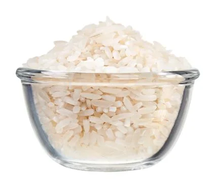 Polished long rice heap in small glass bowl, isolated on white Foto stock