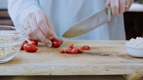 Polished plating process view: adding walnuts and spices to the sauce Stock Photos