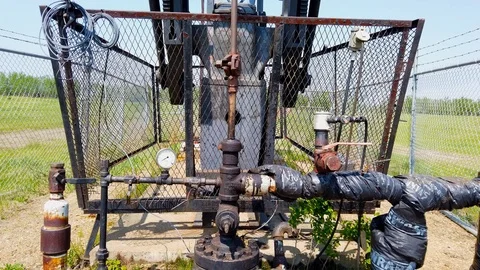 Polished Rod, stuffing box and tee pumping oil on pumpjack in Alberta Oil Fields Stock Footage 109252282