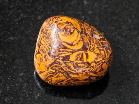 Polished Script stone gemstone on dark Stock Photos