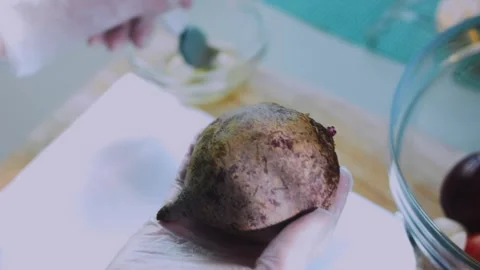 Polished serving moment: peeling a roasted beet Stock Footage 342173220