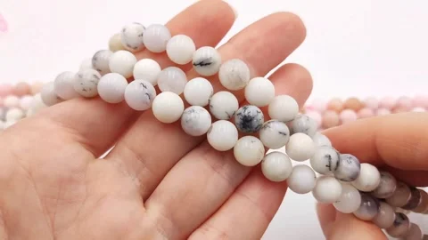 Polished white round gemstone bead strands featuring natural dendrites Stock Footage 345139687