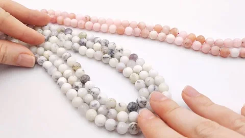 Polished white round gemstone bead strands featuring natural dendrites Stock Footage 345139694