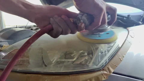 Polishing Car Headlight with Rotary Buffer Tool Stock Footage 336222082