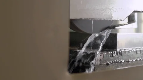 Polishing machine is processing metal detail automatically and pouring it water Stock Footage 100021951