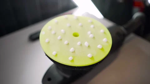 A polishing machine with a yellow disc on which a polishing paste is applied. Video stock 150680939