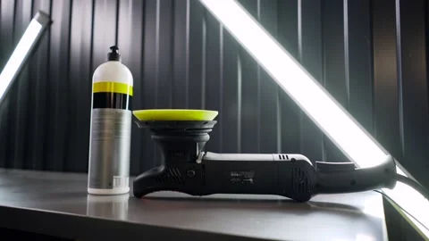 A polishing machine with a yellow round disk is lying on the table of the car Video stock 150680817