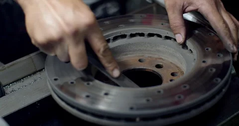Polishing rust behind brake disc.Prepare the hub surface of the brake disc. Stock Footage 294567652