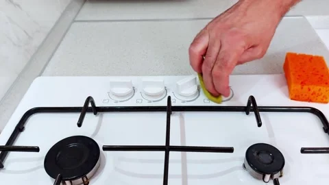 Polishing Stove Knobs with Sponge: A Quick Kitchen Cleanse Video stock 313784245