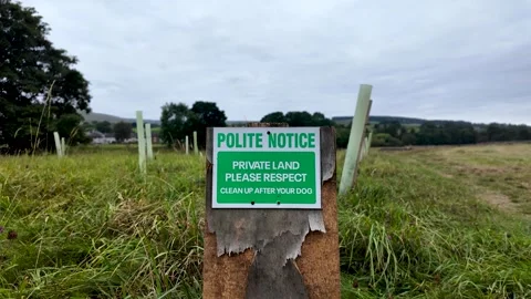 Polite notice asking to clean up after dog in County Durham countryside Stock Footage 316809392