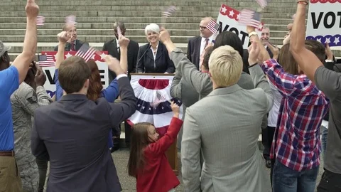 A politician giving a speech in front of an applauding crowd Stock Footage