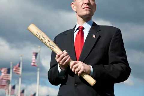 A politician holding a rolled up US Constitution Stock Photos