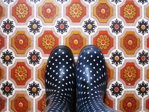 Polka Dot Boots on Patterned floor Stock Photos