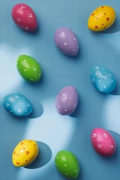 Polka dot Easter eggs on blue background, partly lit by sunlight with crisp Photos