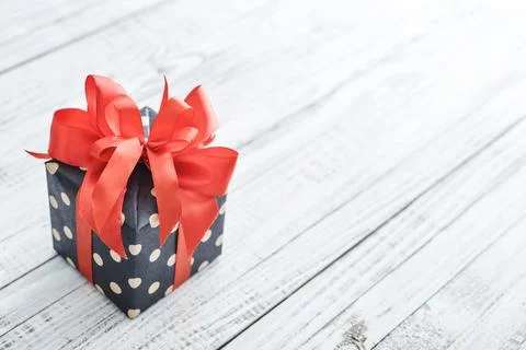 Polka dot Gift box with red ribbon Stock Photos