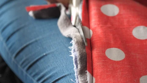 Polka dot material is cut with a pair of scissors 库存影片 129518811