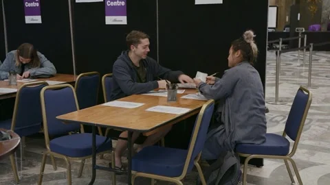 Polling staff at a table inside Australia House Video stock 345298957