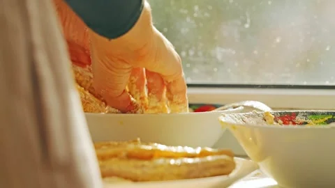 Pollock fillet schnitzel dipped in egg and flour evening sunlight home kitchen Stock Footage 318162189