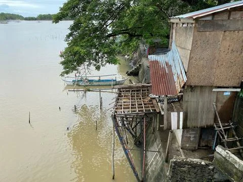 Polluted and stinking huge river teeming with shanty dwellers in a suburban f Stock Photos