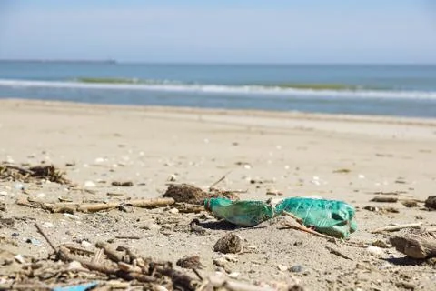 Polluted beach. Discarded plastic bottles and wastes on a beach . Stock Photos