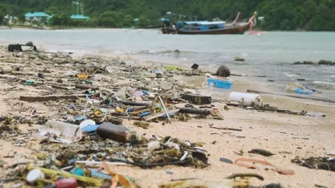 Polluted beach with plastic waste and debris on the sea coast on Phuket island Stock Footage 295055260