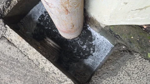 Polluted drain overflowing with bubbling dirty stagnant water, showing Stock Footage 335272608