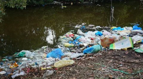 Polluted Planet Garbage Laying At The River Stock Photos