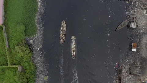 Polluted River with Boats and Floating Garbage - Aerial View Stock Footage 315080516