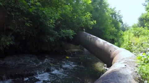 Polluted river. environmental issue pan shot of industrial drains  Stock-Footage 51489824