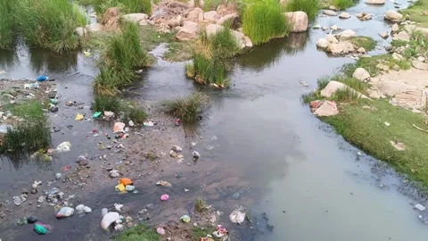 Polluted Stream Flowing Through Rocky Landscape Stock Footage 330324670