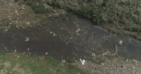 Polluted stream in a poor community Stock Footage 139969297