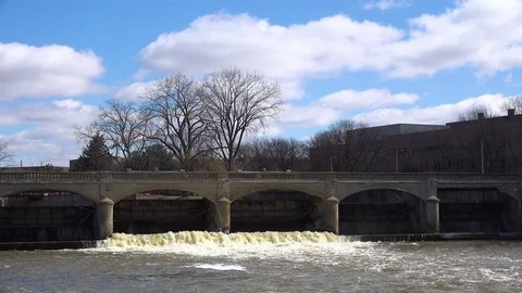 Polluted water flows from the Flint River through Flint, Michigan during their Stock Footage 79392305