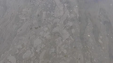 Polluted water running down the stream that leads to the ocean Stock Footage 170178072