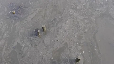 Polluted water running down the stream that leads to the ocean Video stock 170178099