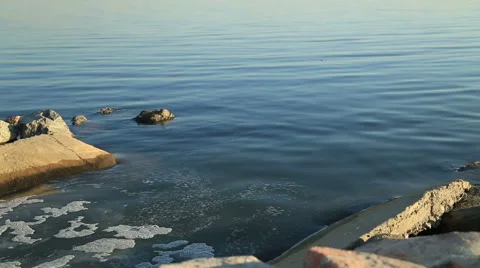 Polluting environment drainage pipe discharging waist products into sea 2 Stock Footage 58885417