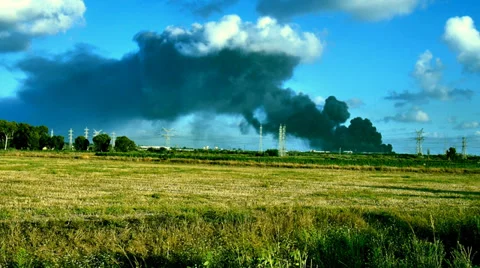 Pollution cloud exploitation chemical black cloud above green filed nature Stock Footage 39681508