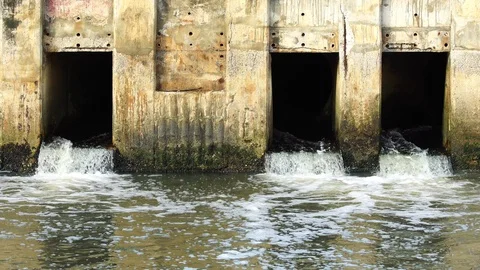 Pollution drain flowing stream to a river Stock Footage 87026744