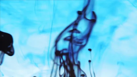 Pollution of the environment. Black ink flowing up and swirling under blue color Stock Footage 158054605