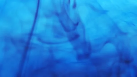 Pollution of the environment. Black ink flowing up and swirling under blue color Video stock 158054749