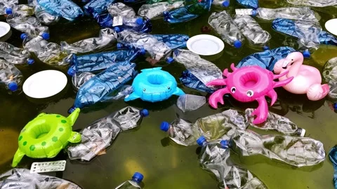 Pollution of the environment. plastic bottles in water and inflatable toys. Stock Footage 139016877