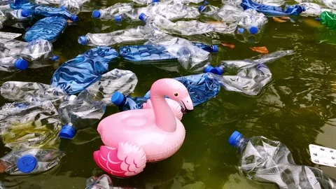 Pollution of the environment. plastic bottles in water and inflatable toys. Stock Footage 139028827