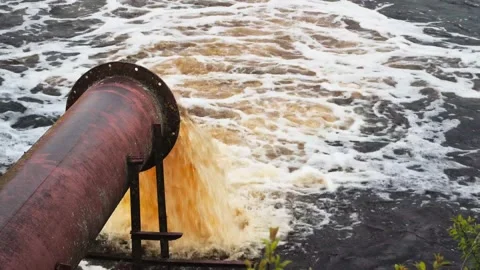 Pollution of the environment, rivers and lakes. Dirty water enters the river Stock-Footage 160733877