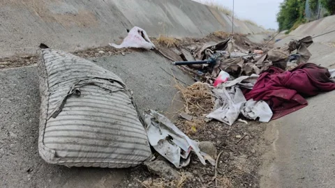 Pollution Grunge Trash Waste Garbage in Ditch Wash Environment California USA Video stock 155211767