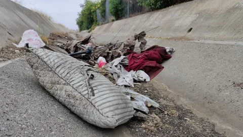 Pollution Grunge Trash Waste Garbage in Ditch Wash Environment California USA Stock Footage 155211986